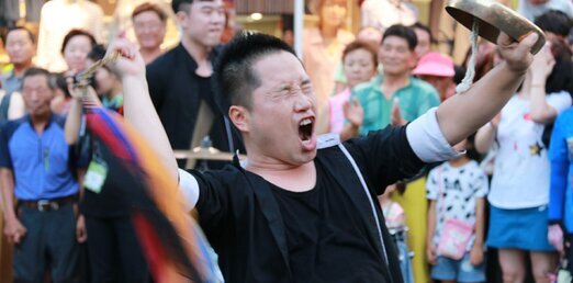 징을 들고 소리를 치고 있는 모습